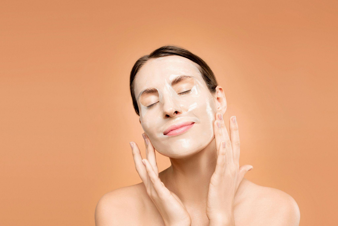 Woman applying a facial mask