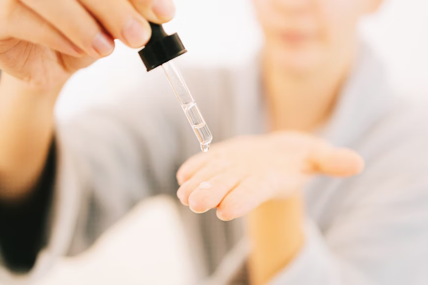 A woman using skincare products